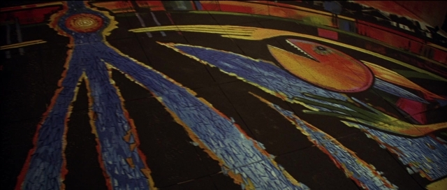 Wide shot frame from Tank Girl — standing, fish, bird
