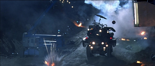 Wide shot frame from Tank Girl — street, car, night
