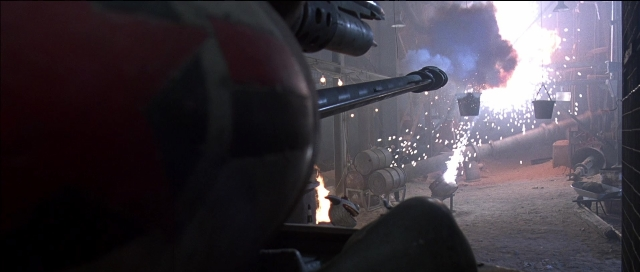 Frame from Tank Girl — hat, hand, gun