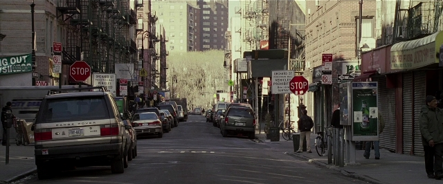 Wide shot frame from Lucky Number Slevin — walking, street, car