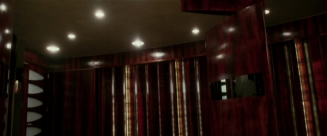 Wide shot frame from Lucky Number Slevin — room, mirror, curtain