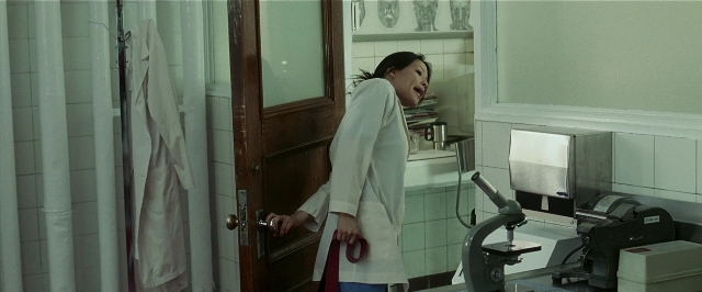 Wide shot frame from Lucky Number Slevin — standing, door, coat
