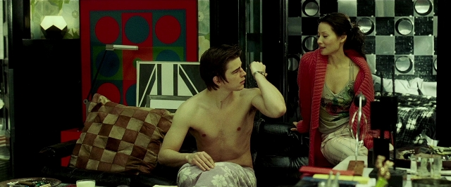 Wide shot frame from Lucky Number Slevin — sitting, room, table