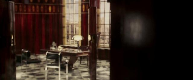 Wide shot frame from Lucky Number Slevin — room, table, chair