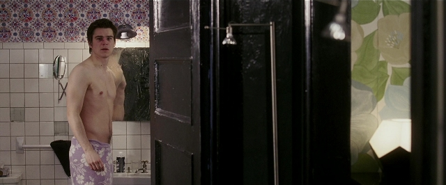 Wide shot frame from Lucky Number Slevin — standing, door, mirror