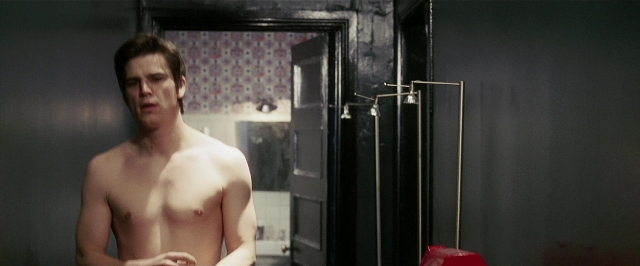 Wide shot frame from Lucky Number Slevin — standing, door, mirror