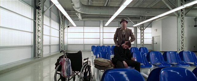 Wide shot frame from Lucky Number Slevin — sitting, standing, room