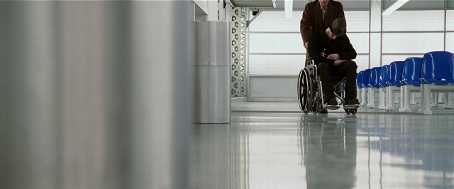 Wide shot frame from Lucky Number Slevin — sitting, room, hat
