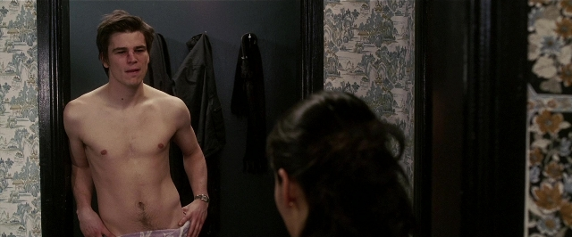 Wide shot frame from Lucky Number Slevin — standing, mirror, coat
