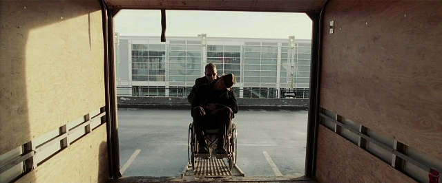 Frame from Lucky Number Slevin — sitting, book, street