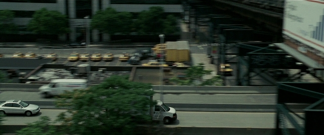 Wide shot frame from Lucky Number Slevin — street, car, truck