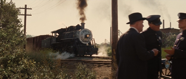 Frame from Water for Elephants — standing, bag, train