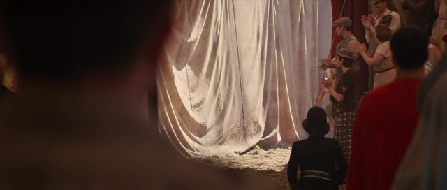 Frame from Water for Elephants — standing, dialogue, hat
