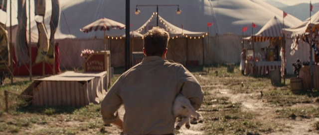 Frame from Water for Elephants — sitting, table, dog