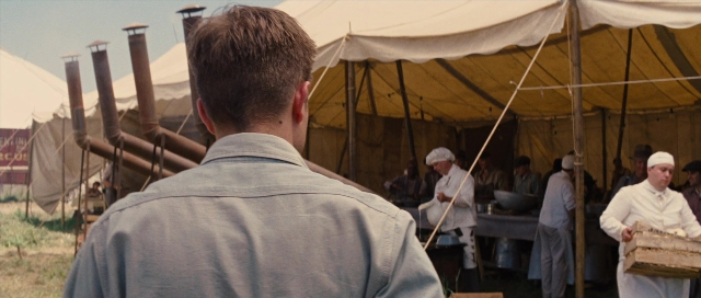 Wide shot frame from Water for Elephants — standing, tent, food