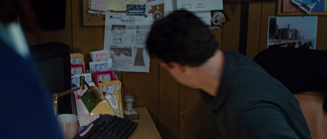 Wide shot frame from Water for Elephants — sitting, hand, shirt