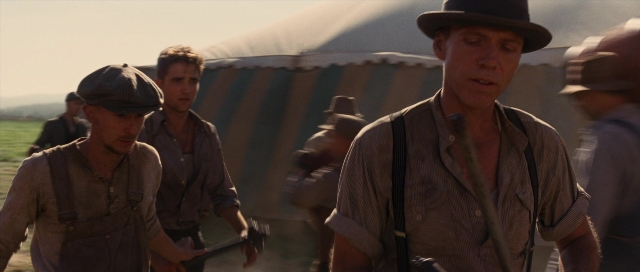 Wide shot frame from Water for Elephants — walking, hat, shirt