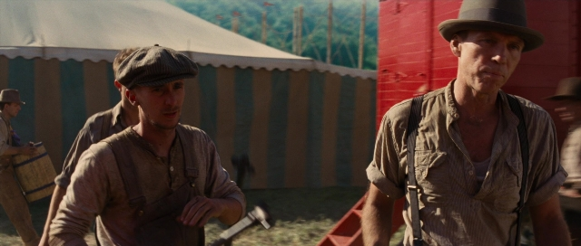 Wide shot frame from Water for Elephants — walking, hat, hand