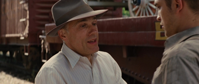 Wide shot frame from Water for Elephants — standing, dialogue, hat