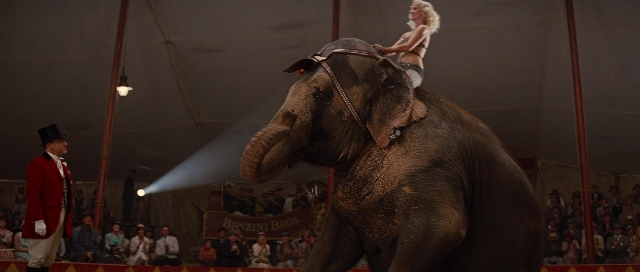 Wide shot frame from Water for Elephants — sitting, standing, hat
