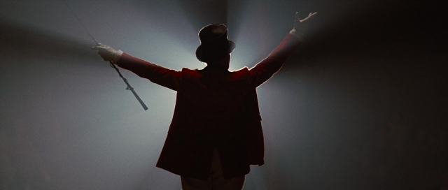 Frame from Water for Elephants — standing, hat, suit