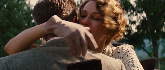 Wide shot frame from Water for Elephants — suit, face, hug