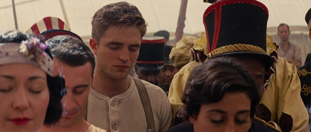 Medium shot frame from Water for Elephants — hat, hand, shirt