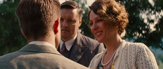 Wide shot frame from Water for Elephants — standing, dialogue, suit