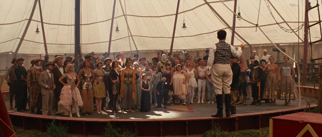 Wide shot frame from Water for Elephants — sitting, standing, hand