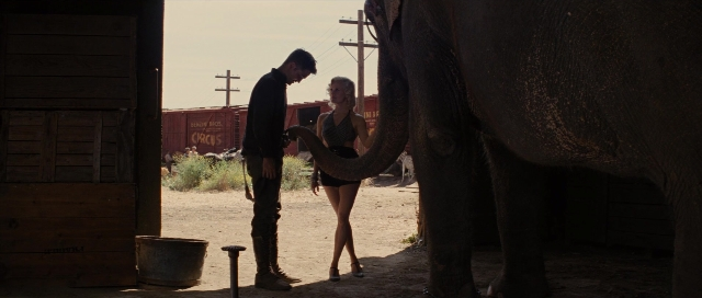 Wide shot frame from Water for Elephants — standing, dialogue, car