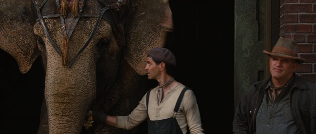 Wide shot frame from Water for Elephants — standing, dialogue, door