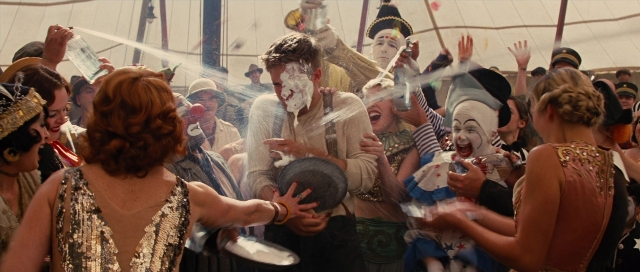Wide shot frame from Water for Elephants — dress, beard, face