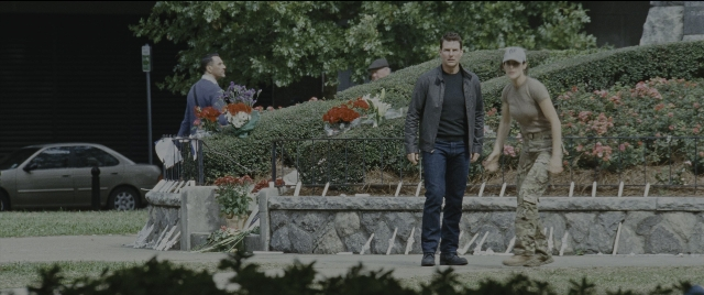 Wide shot frame from Jack Reacher: Never Go Back — walking, bed, street