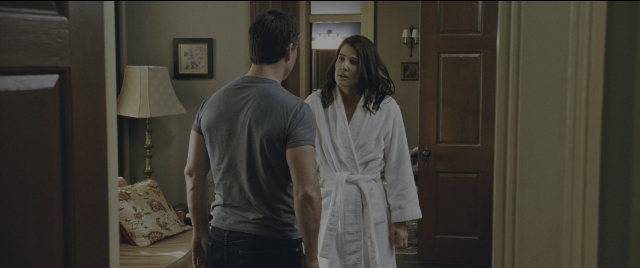 Wide shot frame from Jack Reacher: Never Go Back — standing, room, bed