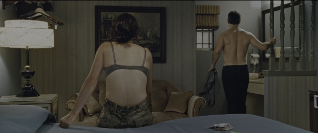 Wide shot frame from Jack Reacher: Never Go Back — sitting, standing, room