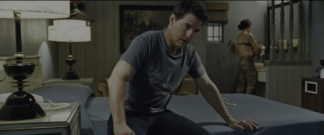 Wide shot frame from Jack Reacher: Never Go Back — sitting, standing, room