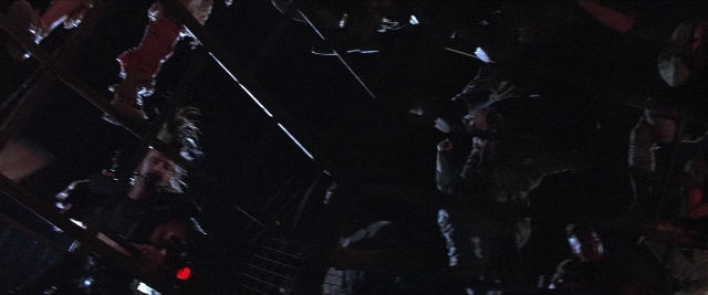 Wide shot frame from Mad Max Beyond Thunderdome — standing, room, person