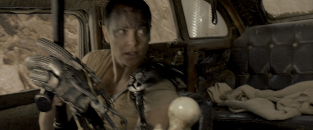 Medium shot frame from Mad Max: Fury Road — sitting, bed, car