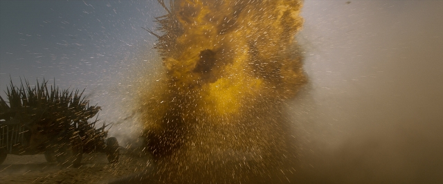 Wide shot frame from Mad Max: Fury Road — walking, fountain, person