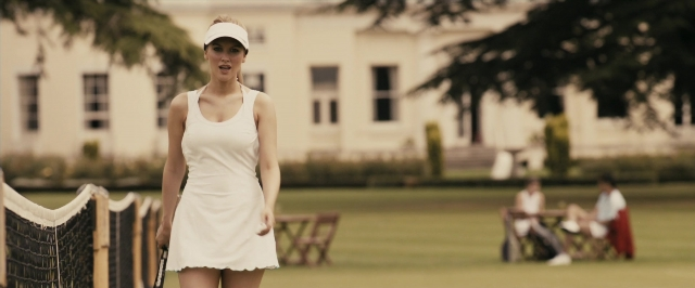 Medium shot frame from RocknRolla — sitting, standing, hand