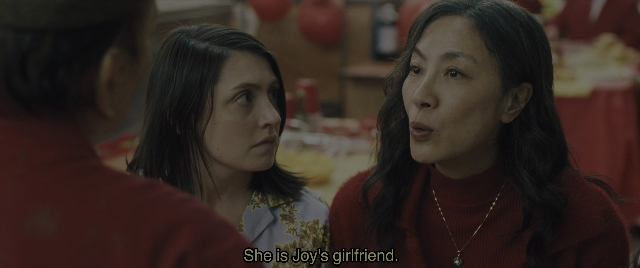 Medium shot frame from Everything Everywhere All at Once — sitting, table, dialogue