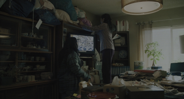 Wide shot frame from Everything Everywhere All at Once — sitting, standing, room