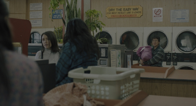 Wide shot frame from Everything Everywhere All at Once — standing, room, dialogue