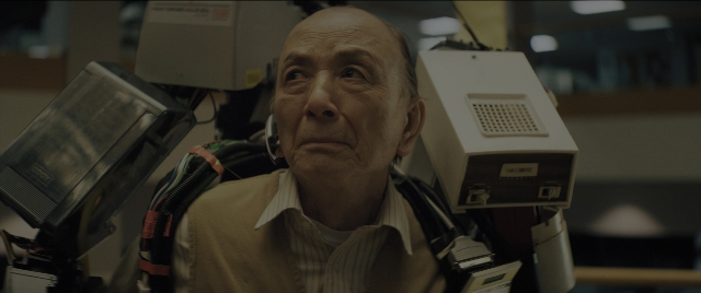 Medium shot frame from Everything Everywhere All at Once — sitting, shirt, chair