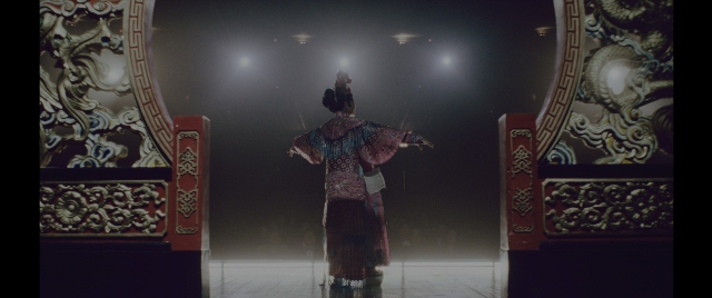 Wide shot frame from Everything Everywhere All at Once — standing, dress, person