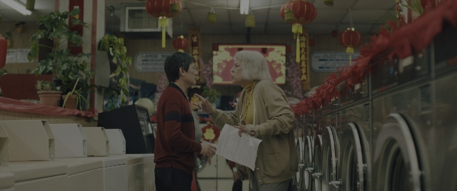 Wide shot frame from Everything Everywhere All at Once — standing, room, dialogue