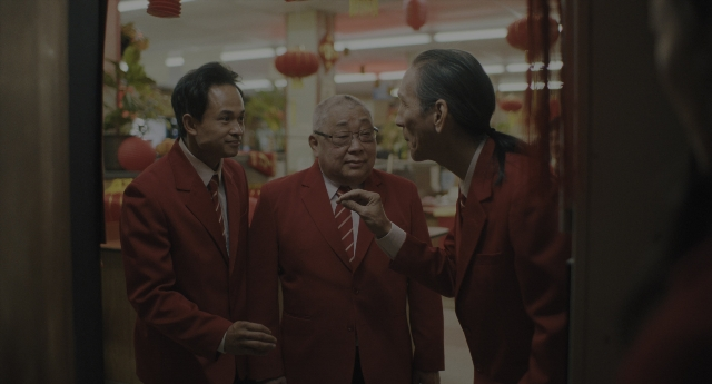 Wide shot frame from Everything Everywhere All at Once — room, dialogue, hand