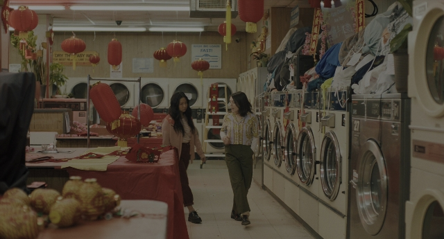 Wide shot frame from Everything Everywhere All at Once — walking, room, table