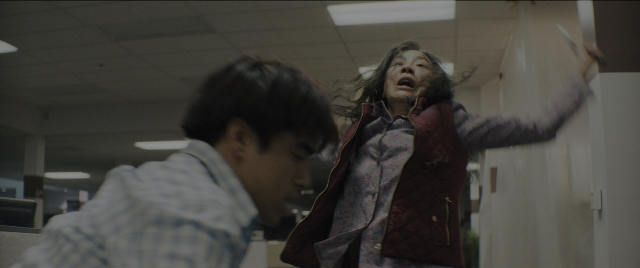 Frame from Everything Everywhere All at Once — standing, office, face