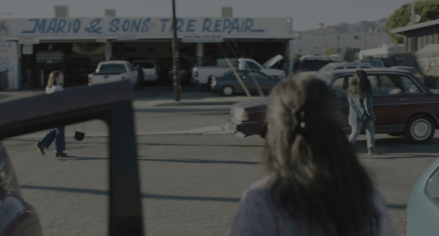 Medium shot frame from Everything Everywhere All at Once — walking, car, shirt